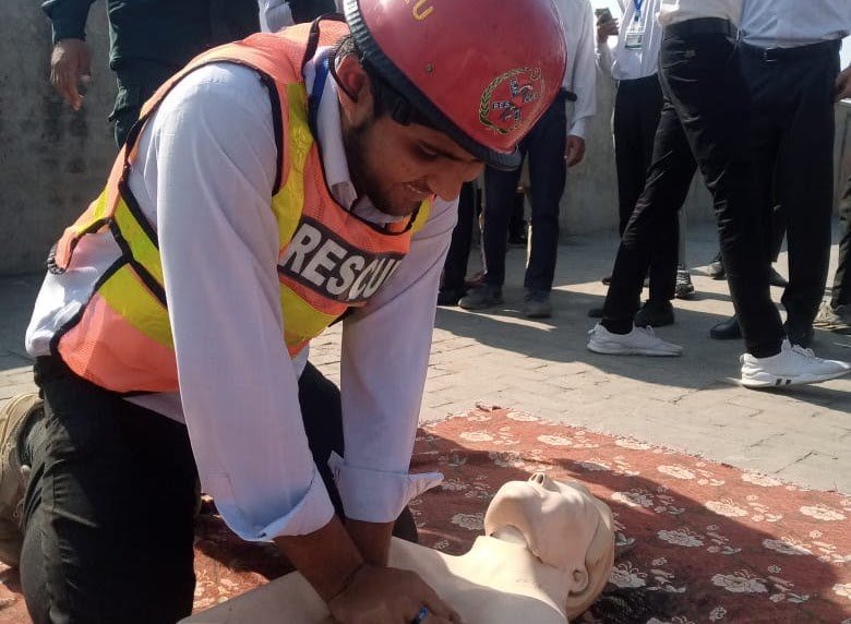 Trainee practicing CPR on a rescue dummy