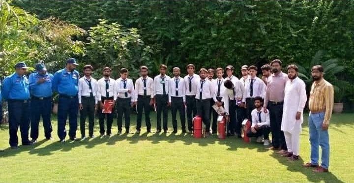 Group photo in a garden with fire extinguishers