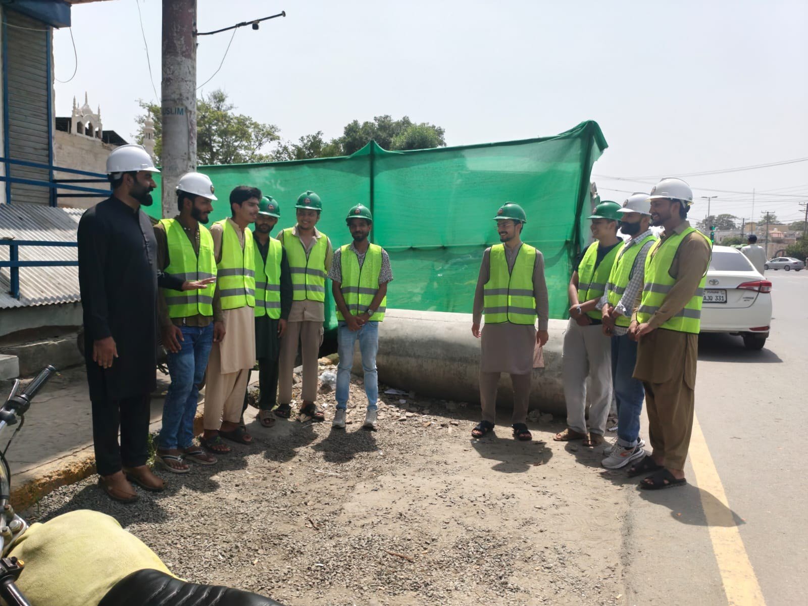 Trainees in high-visibility vests on a site visit