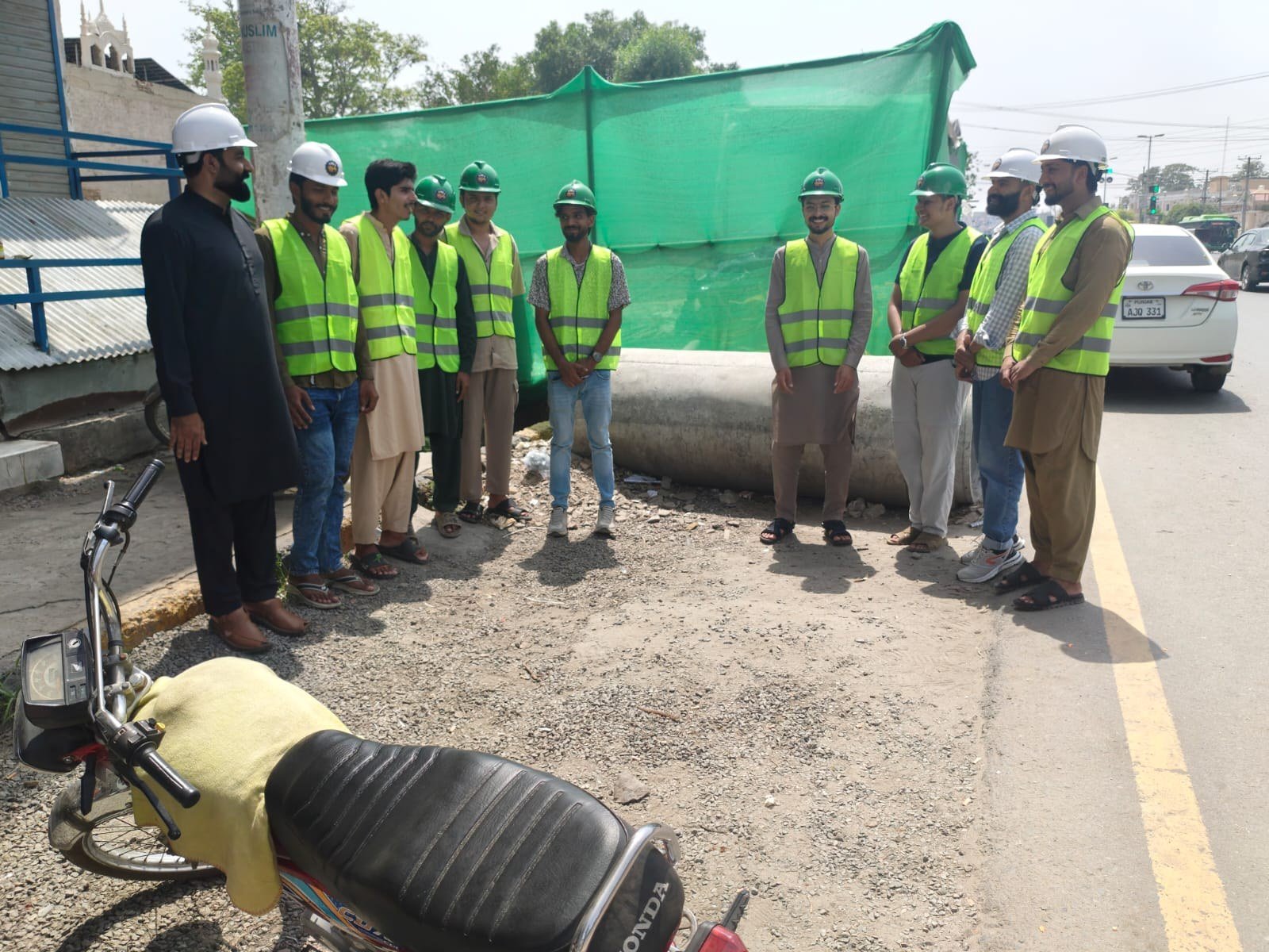 Trainees in high-visibility vests during a roadside site briefing