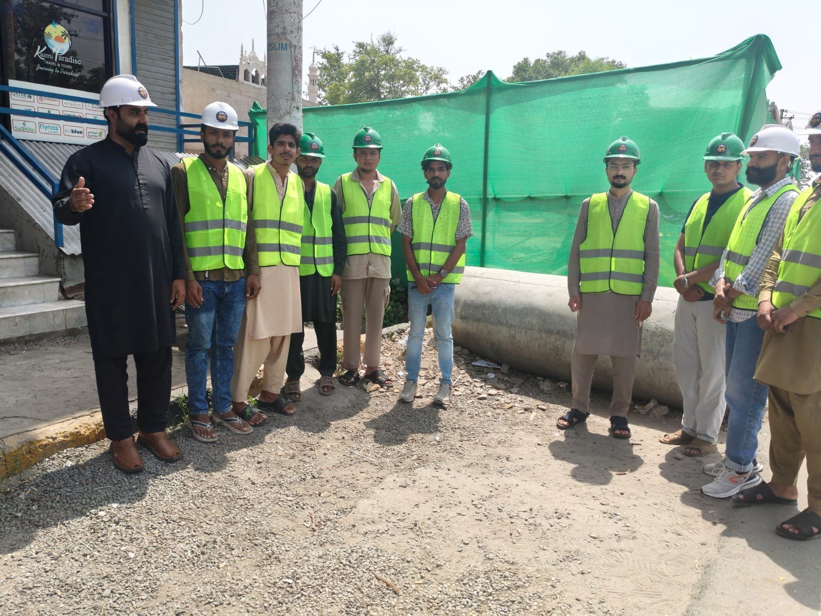 Trainees in high-visibility vests during a roadside site briefing