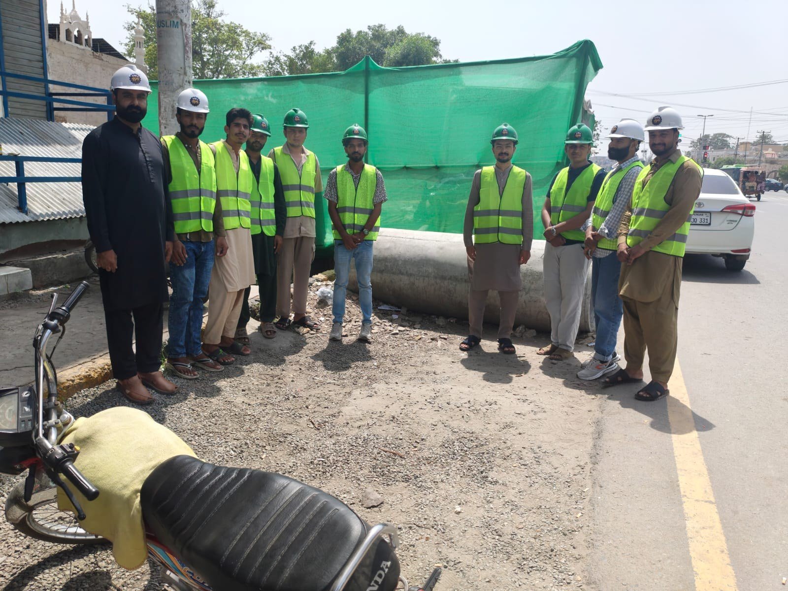Trainees in high-visibility vests during a roadside site briefing